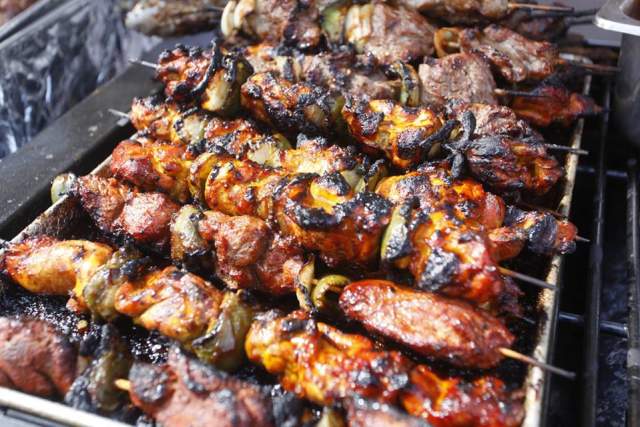 Jerk Chicken Kebabs smoking on a grill