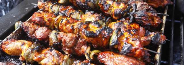 Jerk Chicken Kebabs smoking on a grill