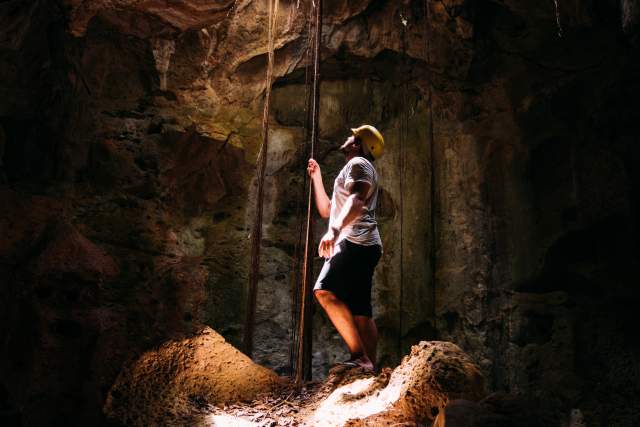 Man in lit cavern